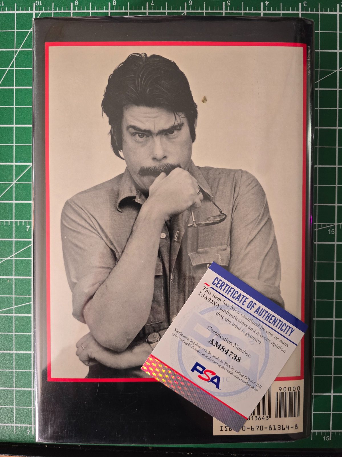 Back cover of Misery with a PSA certificate of authenticity placed over the book.